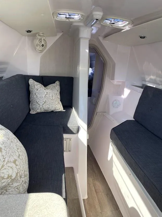 Slide: The Image of Interior of 2017 Corsair Cruze 970 sailboat with cozy seating and decorative pillows. - 23