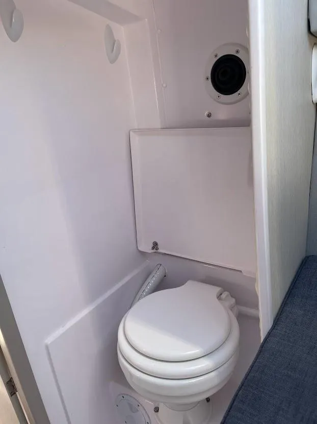 Slide: The Image of 2017 Corsair Cruze 970 #396 boat interior with compact marine toilet. - 27