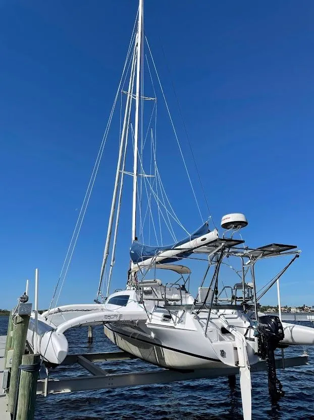 Slide: The Image of 2017 Corsair Cruze 970 #396 sailboat docked under clear blue sky. - 3