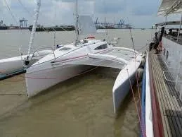 Slide: The Image of 2017 Corsair Cruze 970 #396 trimaran docked beside a pier on a cloudy day. - 8