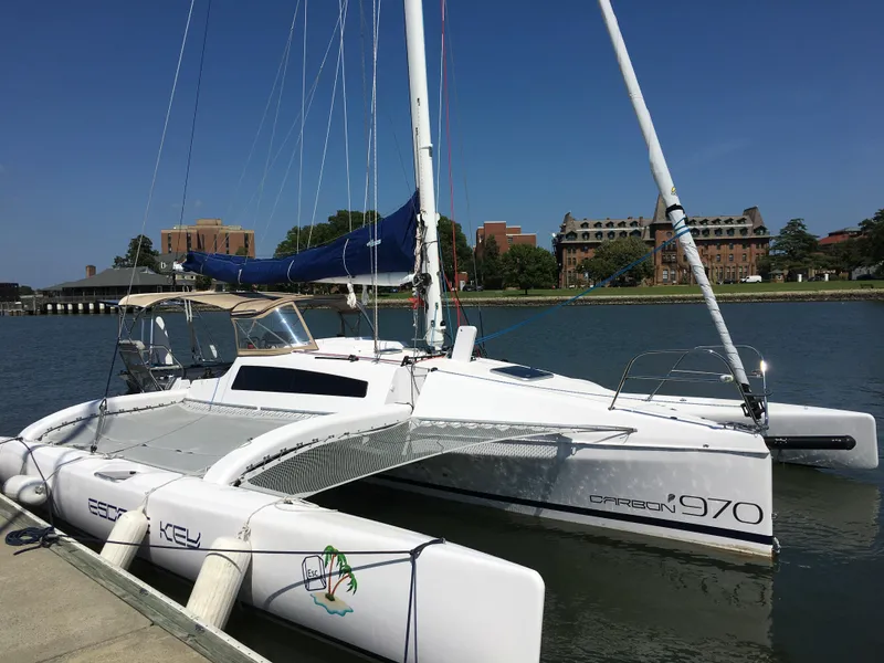 Slide: The Image of 2017 Corsair Cruze 970 trimaran docked by a scenic waterfront. - 9