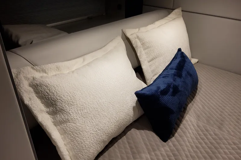 Slide: The Image of Luxurious bedding with white and blue pillows on a Formula 400 Super Sport Crossover, 2026. - 105