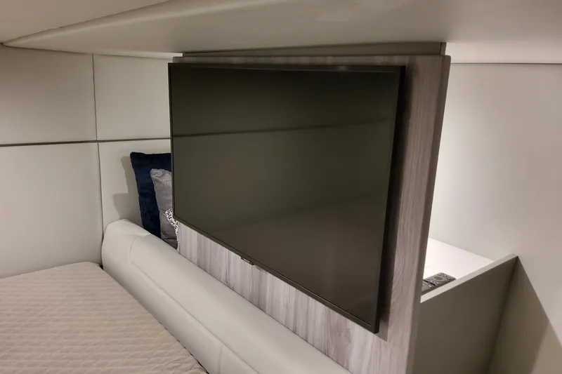 Slide: The Image of Interior of 2026 Formula 400 Super Sport Crossover with wall-mounted TV and plush bedding. - 108