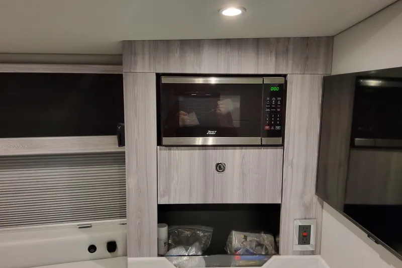 Slide: The Image of Modern kitchen area in 2026 Formula 400 Super Sport Crossover with microwave and sleek cabinetry. - 116