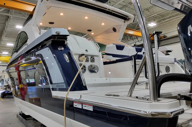 Slide: The Image of 2026 Formula 400 Super Sport Crossover luxury boat in a showroom setting. - 12