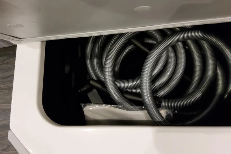 Slide: The Image of Coiled hoses in storage compartment of 2026 Formula 400 Super Sport Crossover. - 124