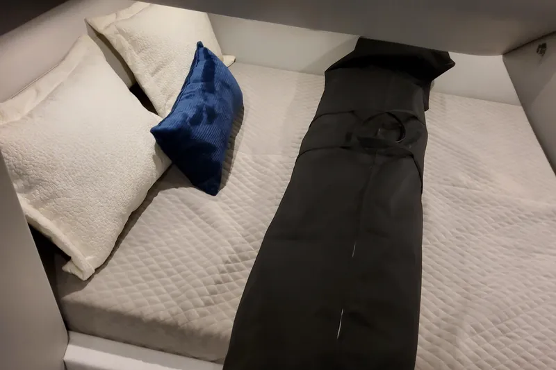 Slide: The Image of Cozy cabin bed in 2026 Formula 400 Super Sport Crossover with pillows and quilted bedding. - 136