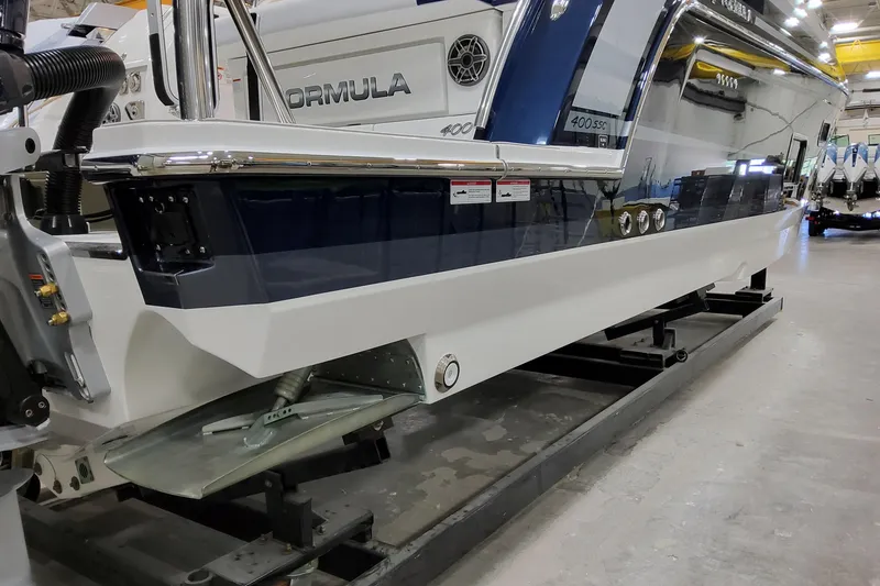 Slide: The Image of 2026 Formula 400 Super Sport Crossover boat in a showroom, side view. - 20