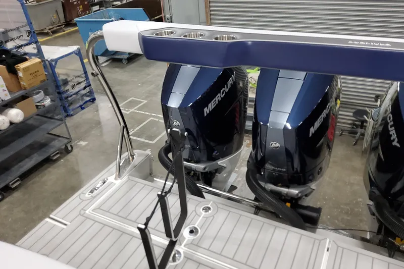 Slide: The Image of 2026 Formula 400 Super Sport Crossover with Mercury outboard engines in a workshop setting. - 24