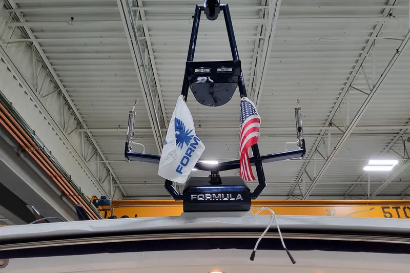 Slide: The Image of 2026 Formula 400 Super Sport Crossover with flags in a warehouse setting. - 27