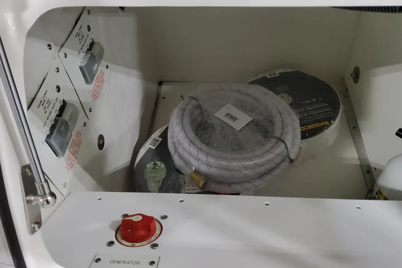 Slide: The Image of Storage compartment in 2026 Formula 400 Super Sport Crossover with coiled rope and generator switch. - 30