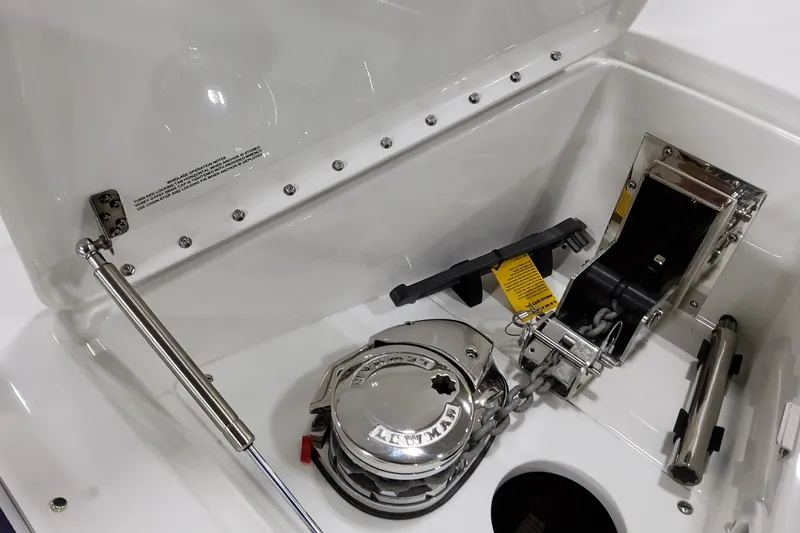 Slide: The Image of Anchor compartment of 2026 Formula 400 Super Sport Crossover boat, featuring winch and chain. - 39