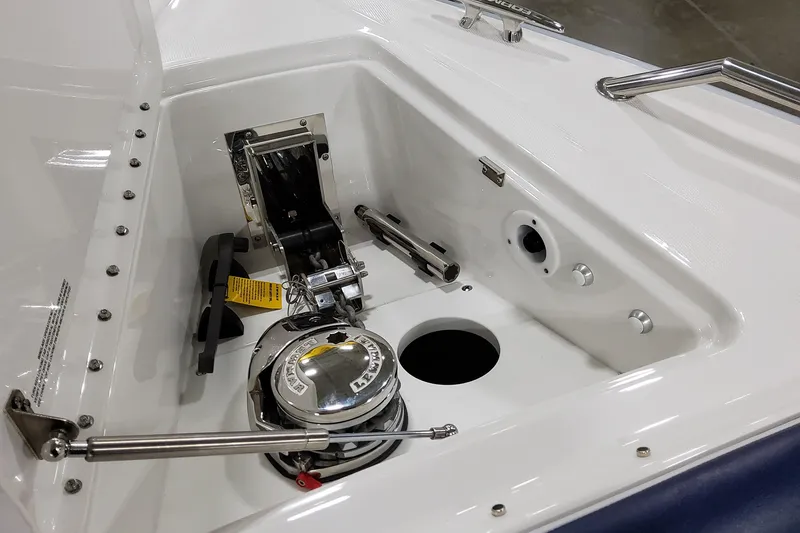 Slide: The Image of 2026 Formula 400 Super Sport Crossover boat anchor compartment with winch and stainless steel fittings. - 40