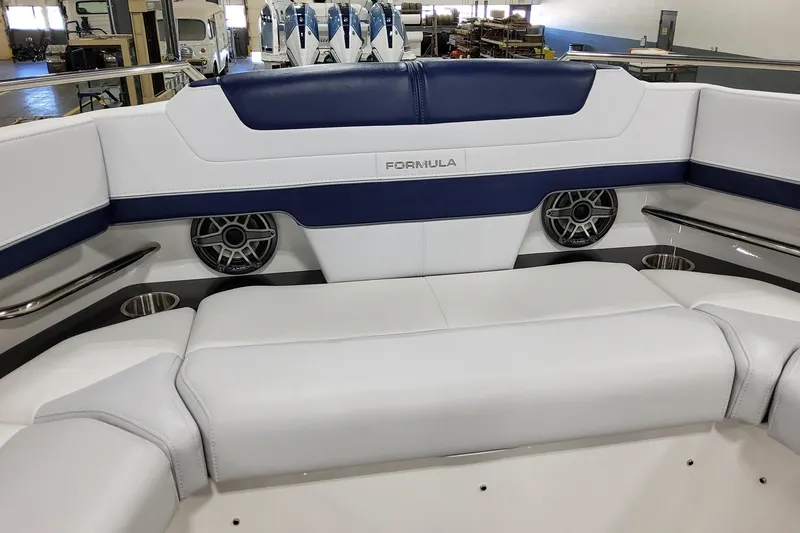 Slide: The Image of 2026 Formula 400 Super Sport Crossover boat interior with white and blue seating, speakers, and cup holders. - 47