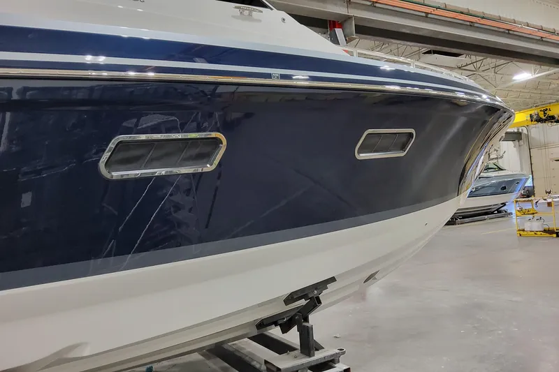 Slide: The Image of 2026 Formula 400 Super Sport Crossover boat in a showroom, showcasing sleek design. - 5