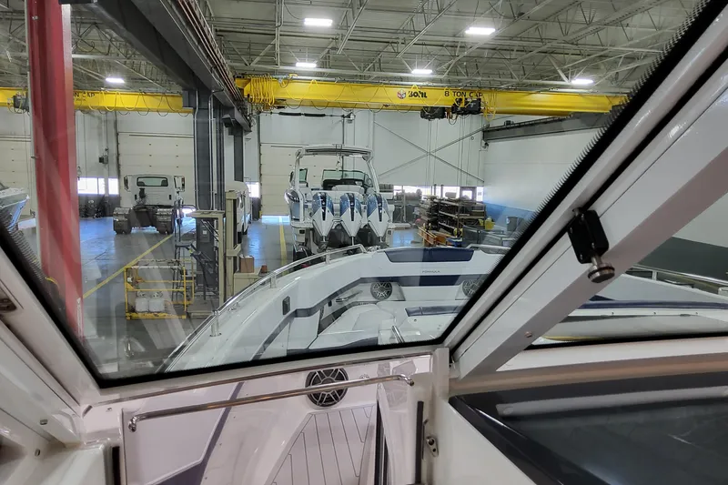 Slide: The Image of Interior view of a 2026 Formula 400 Super Sport Crossover in a boat workshop. - 55