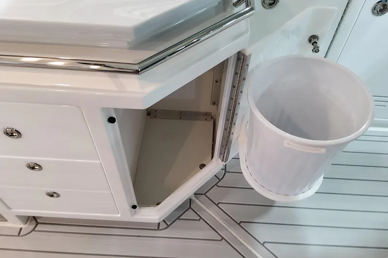 Slide: The Image of Interior of 2026 Formula 400 Super Sport Crossover with open storage and trash bin. - 68