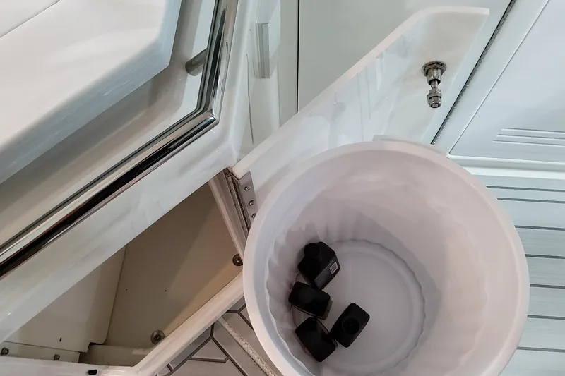 Slide: The Image of Open cabinet with a white bucket inside a 2026 Formula 400 Super Sport Crossover. - 69