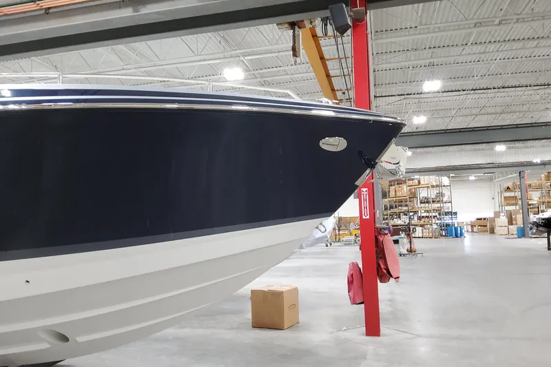 Slide: The Image of 2026 Formula 400 Super Sport Crossover boat in a spacious warehouse setting. - 7