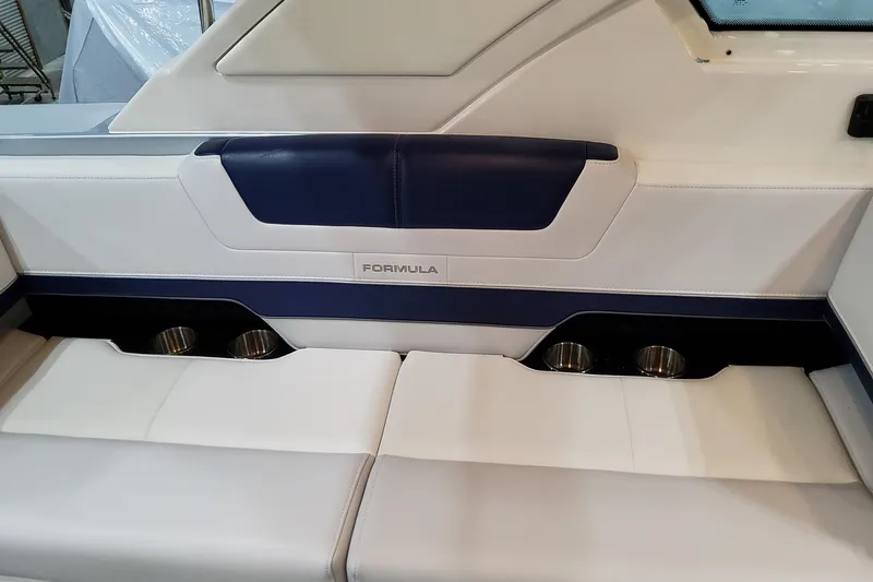 Slide: The Image of 2026 Formula 400 Super Sport Crossover interior seating with cup holders, featuring blue and white upholstery. - 73