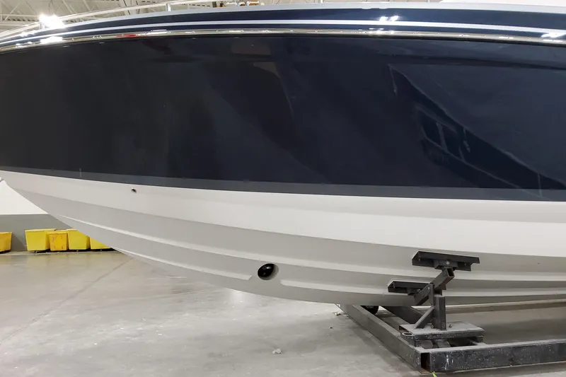 Slide: The Image of 2026 Formula 400 Super Sport Crossover boat hull in a showroom setting. - 9