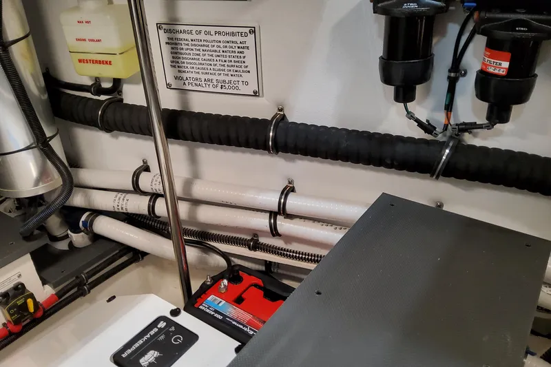 Slide: The Image of Engine room of 2026 Formula 400 Super Sport Crossover with visible components and warning sign. - 91