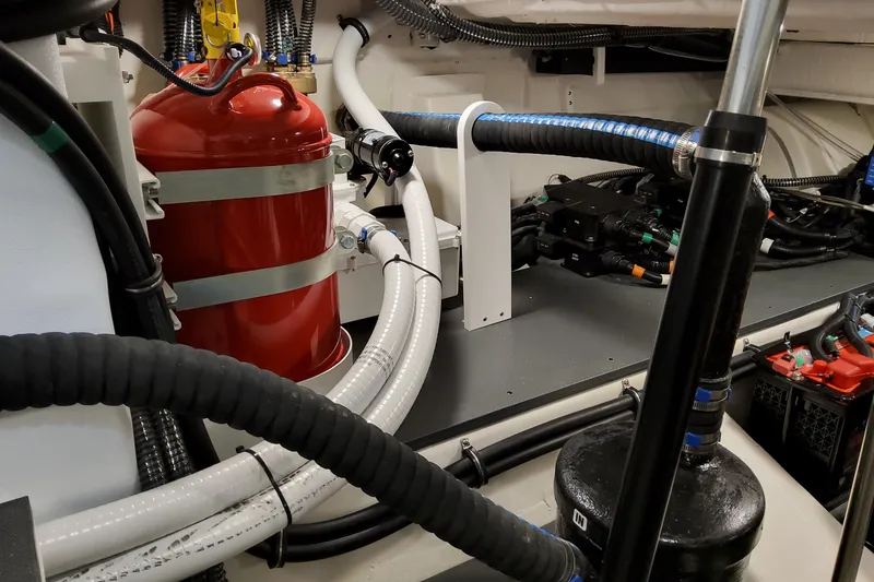 Slide: The Image of Engine room of 2026 Formula 400 Super Sport Crossover with red fire extinguisher and cables. - 93