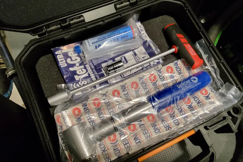 Slide: The Image of Tool kit with various tools and lubricant, suitable for Formula 400 Super Sport Crossover maintenance. - 98