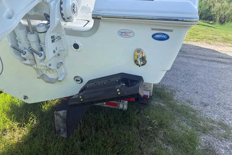Slide: The Image of Rear view of 2026 Tidewater 282 CC Adventure boat on trailer, showing engine mount details. - 11