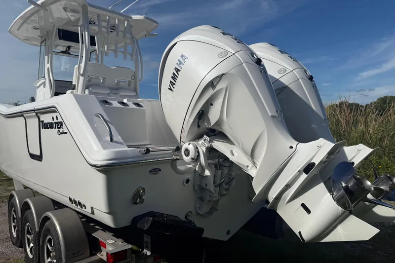 Slide: The Image of 2026 Tidewater 282 CC Adventure boat with dual Yamaha engines on a trailer. - 12