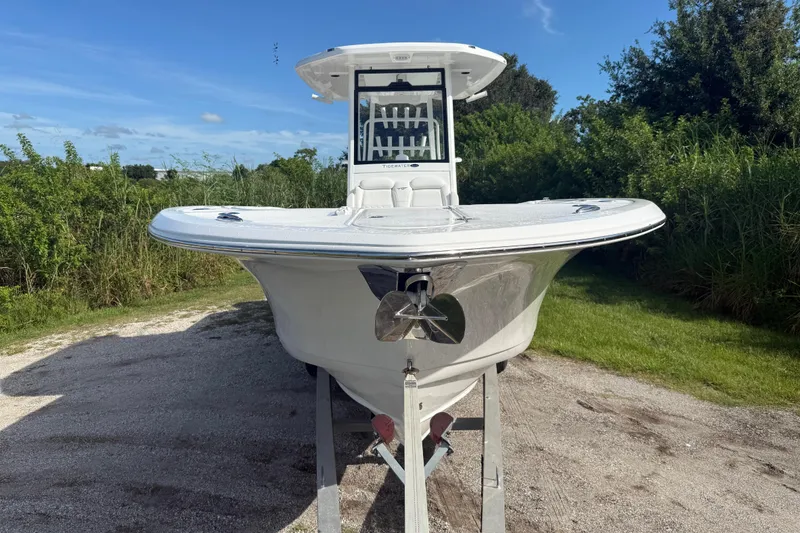 Slide: The Image of 2026 Tidewater 282 CC Adventure boat on trailer, surrounded by greenery. - 17