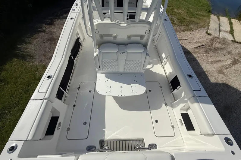 Slide: The Image of 2026 Tidewater 282 CC Adventure boat interior, spacious deck with seating and storage compartments. - 18