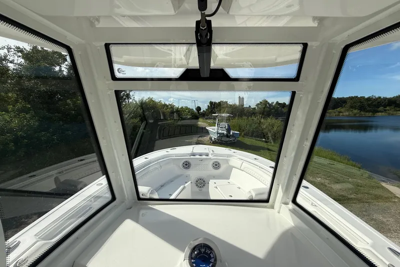 Slide: The Image of Interior view of 2026 Tidewater 282 CC Adventure boat, showcasing helm and windshield. - 23