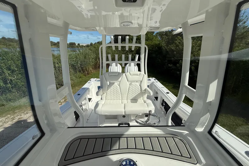 Slide: The Image of 2026 Tidewater 282 CC Adventure boat interior with modern seating and steering wheel. - 29