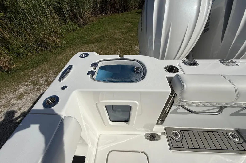 Slide: The Image of 2026 Tidewater 282 CC Adventure boat deck with seating and storage features. - 33