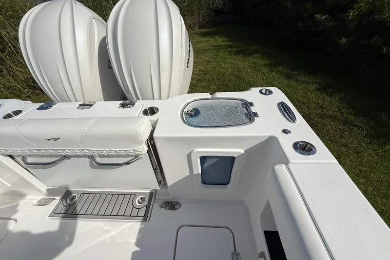 Slide: The Image of 2026 Tidewater 282 CC Adventure boat deck with dual engines and seating area. - 35