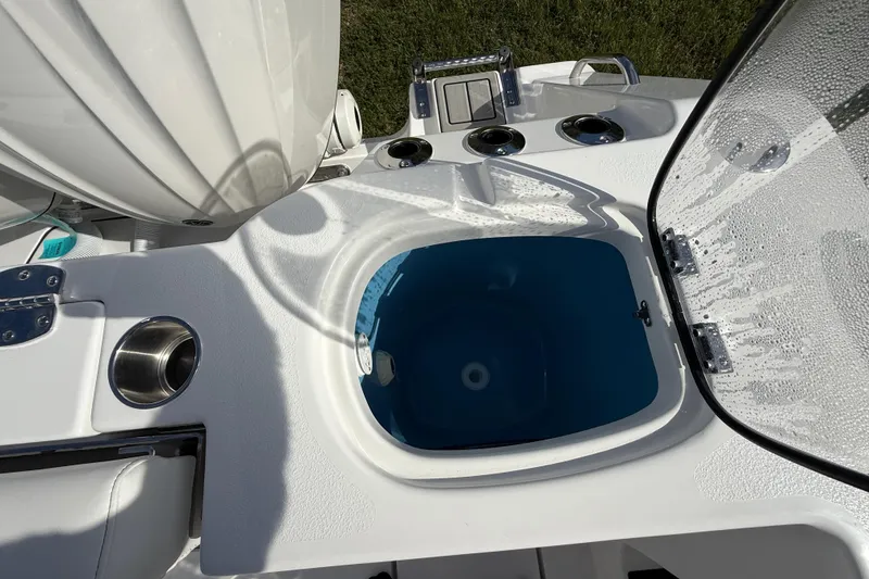 Slide: The Image of 2026 Tidewater 282 CC Adventure boat with open livewell and cup holders. - 36