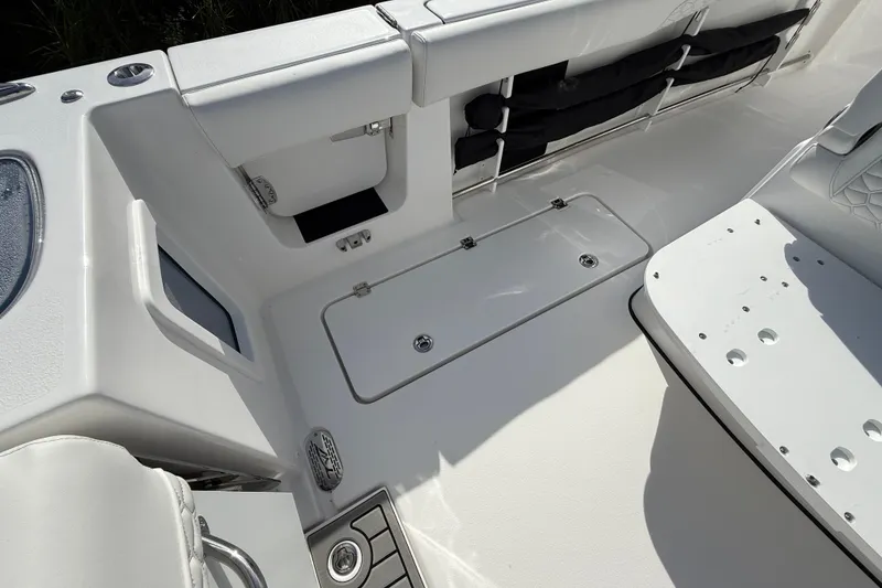 Slide: The Image of 2026 Tidewater 282 CC Adventure boat interior with storage compartments and seating. - 39