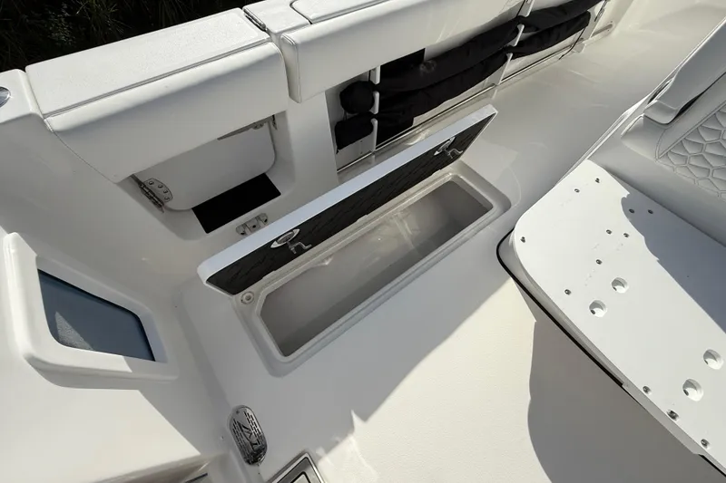 Slide: The Image of 2026 Tidewater 282 CC Adventure boat interior with open storage compartment and seating. - 40