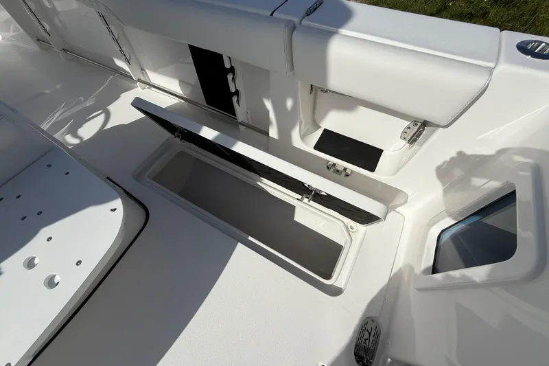 Slide: The Image of 2026 Tidewater 282 CC Adventure boat interior with open storage compartment. - 42