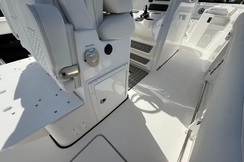 Slide: The Image of 2026 Tidewater 282 CC Adventure boat interior with white seating and control panel. - 43