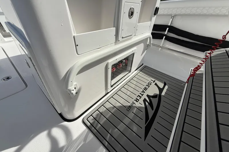 Slide: The Image of 2026 Tidewater 282 CC Adventure boat interior with branded flooring and storage compartment. - 45