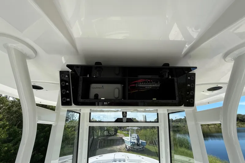 Slide: The Image of 2026 Tidewater 282 CC Adventure boat console with Garmin electronics and open storage compartment. - 47
