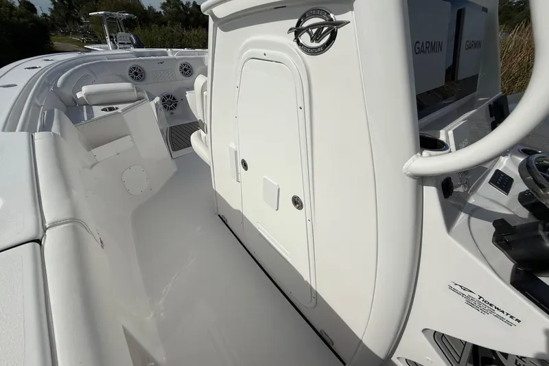 Slide: The Image of 2026 Tidewater 282 CC Adventure boat interior with Garmin electronics and seating area. - 48