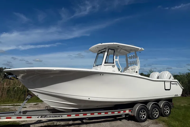 The Image of 2026 Tidewater 282 CC Adventure boat on trailer under clear blue sky. - 5