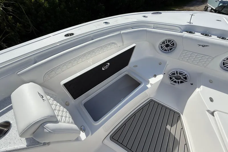 Slide: The Image of 2026 Tidewater 282 CC Adventure boat interior with seating, storage, and speakers. - 52
