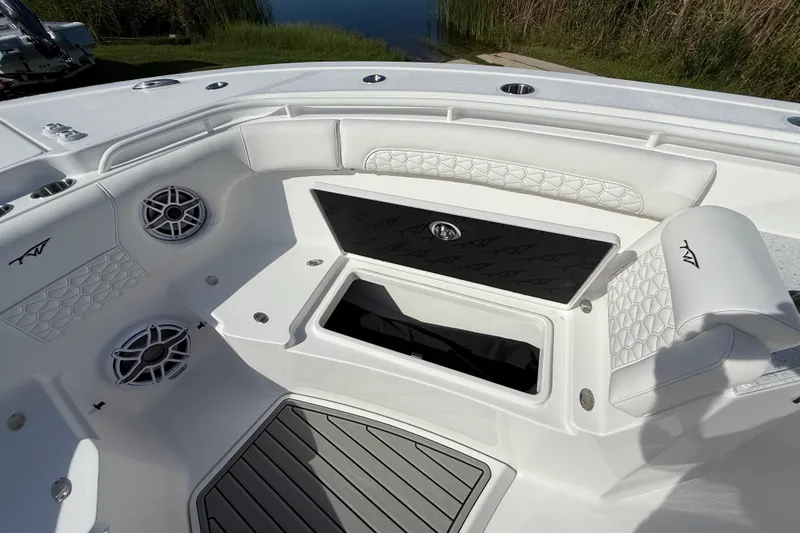 Slide: The Image of 2026 Tidewater 282 CC Adventure boat interior with white seating and storage compartment. - 53