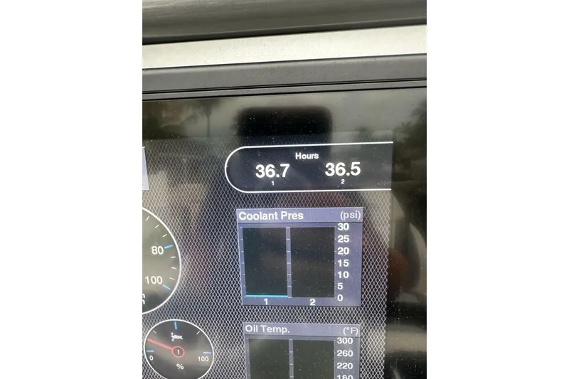 Slide: The Image of Dashboard display of a 2021 ShearWater 270 Carolina Flare boat showing engine hours and gauges. - 13