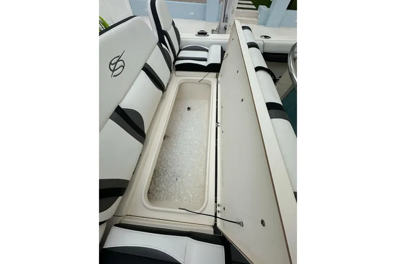 Slide: The Image of 2021 ShearWater 270 Carolina Flare boat with open storage compartment filled with ice. - 21