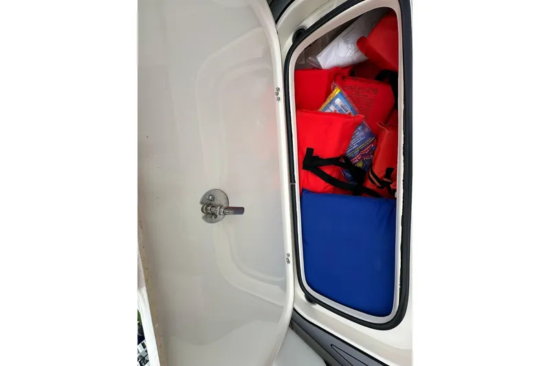 Slide: The Image of Storage compartment with life jackets on a 2021 ShearWater 270 Carolina Flare boat. - 22